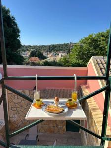 a table with a plate of food on a balcony at Stavroula's House in Argyrádes