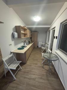 a kitchen with a table and chairs in a room at Casa Maria in Vama Veche