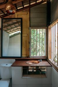 a bathroom with a sink and a toilet and windows at Sikepan Villa Borobudur in Mendut +29 photos