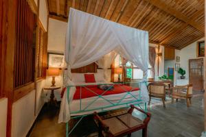 a bedroom with a bed with a canopy at Sikepan Villa Borobudur in Mendut