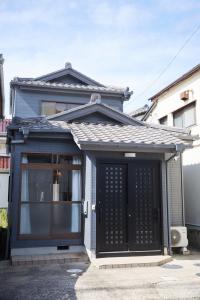 a front door of a house with a black door at Knot Kyonan in Katsuyama +17 photos