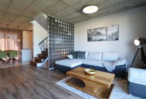 a living room with a couch and a coffee table at LomniSki apartment in Veľká Lomnica