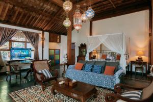 a living room with a blue couch in a room at Sikepan Villa Borobudur in Mendut