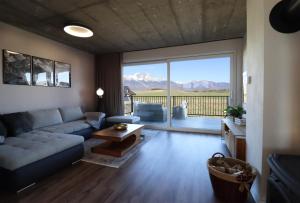 a living room with a couch and a table at LomniSki apartment in Veľká Lomnica +24 photos