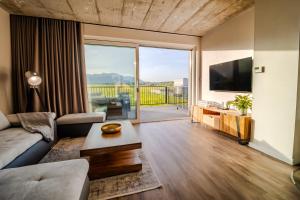 a living room with a couch and a tv at LomniSki apartment in Veľká Lomnica