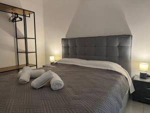 a bedroom with a large bed with two pillows on it at Lemon Tree Residence in Artemida