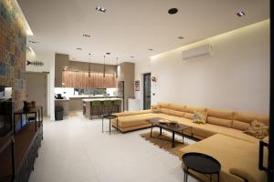 a living room with a couch and a table at Blooms Villa in Al Rama