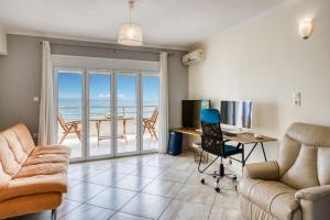 a living room with a view of the ocean at Komi Shoreline Blue Window in Kómi