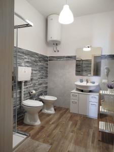 a bathroom with a toilet and a sink at Acquamarina B&B Deluxe in Cariati +25 photos