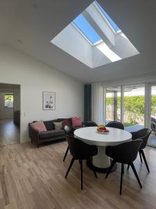 a living room with a white table and chairs at Spacious Luxury Villa in Copenhagen in Copenhagen