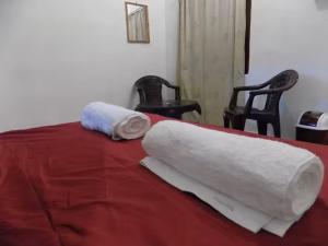 a bed with two towels on top of it at Sajee Residence Nilaveli in Trincomalee