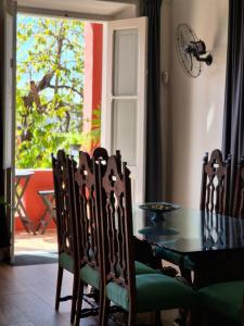 a dining room with a glass table and chairs at Guesthouse Villa Dourada in Rio de Janeiro