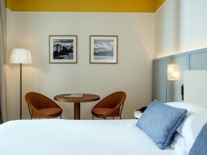 a hotel room with a bed and a table and chairs at Hotel Plaza in Sorrento +38 photos