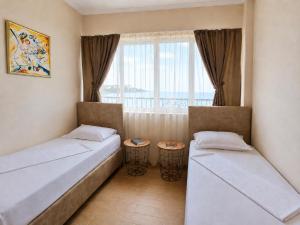 a room with two beds and a window at Effect Saint Mina - SELF CHECK-IN in Sozopol +43 photos
