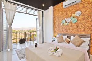 a bedroom with a bed with a cat sitting on it at I EMPYREAN STAYS ll MYSTICAL STONE VILLA ll 4BHK II AC II PRIVATE POOL II in Lonavala +53 photos
