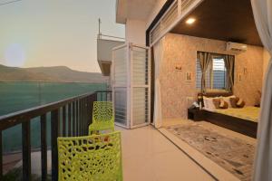 a room with a balcony with a bed and a bedroom at I EMPYREAN STAYS ll MYSTICAL STONE VILLA ll 4BHK II AC II PRIVATE POOL II in Lonavala