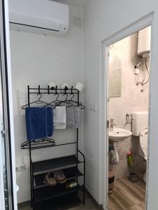 a bathroom with a towel rack and a sink at air&wizz II in Dubrave Gornje