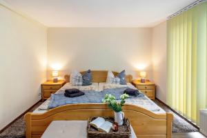a bedroom with a bed and two night stands at Ferienhaus Kleine Auszeit in Bleicherode