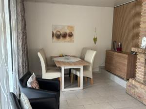 a dining room with a table and chairs at Ferienhaus 251 in Burhave in Burhave +17 photos
