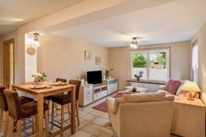 a living room with a table and a dining room at Ferienhaus Kleine Auszeit in Bleicherode