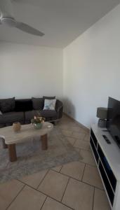 a living room with a couch and a coffee table at Une Parenthèse à 2 in Saint-Joseph