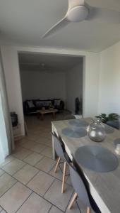 a living room with a table and a couch at Une Parenthèse à 2 in Saint-Joseph