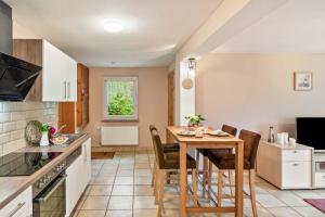 a kitchen and dining room with a table and chairs at Ferienhaus Kleine Auszeit in Bleicherode