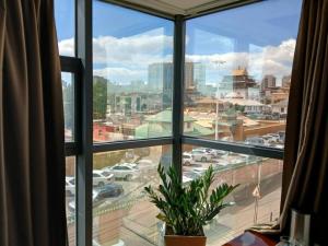 a window with a view of a city at Gandan Peace Guest House in Ulaanbaatar