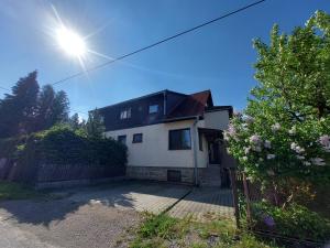 a white house with the sun in the sky at Forester Apartment Zuberec in Zuberec