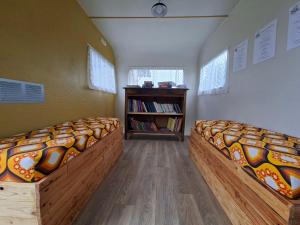 two beds in a room with a book shelf at Chambres d'hotes aux Petits Belézins in Saint-Amour