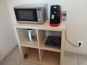 a microwave oven sitting on top of a shelf at Studio La Gière in Beaumes-de-Venise +7 photos
