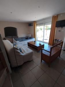 a living room with a couch and a table at Studio La Gière in Beaumes-de-Venise