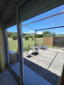 a view of a patio from a sliding glass door at Studio La Gière in Beaumes-de-Venise