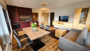 a kitchen and living room with a table and a couch at Berggasthaus Steinerkogl in Brandberg