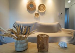 a room with a bed and a table with a vase at Kleopatra's Apartments in Chios