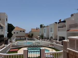 arial view of a building with a pool and buildings at Casa Atalaya Playa R&R in Aguadulce