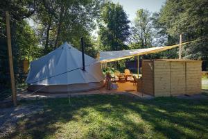 a tent in a yard with a table and chairs at Apartmány Maříž in Maříž
