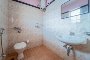 a bathroom with a toilet and a sink at Margao Residency in Madgaon +18 photos