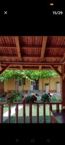 a porch with a wooden roof with flowers and plants at Casa Cami in Jurilovca