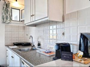 a kitchen with a sink and a counter top at Voula Accommodation in Agios Georgios