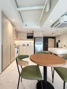 a kitchen with a table and chairs in a room at Coliwoo Midtown - CoLiving in Singapore +45 photos