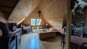 a living room with a vaulted ceiling and a room with a table at Agroturystyka SPA in Zelków