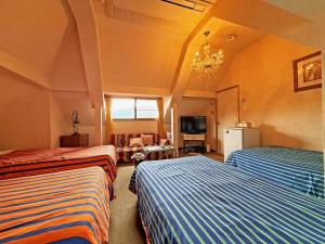 a bedroom with two beds and a living room at Nikko Park Lodge Mountain Side in Nikko