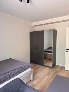 a bedroom with a bed and a mirror at Mõisavälja apartment in Rakvere