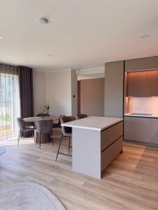 an open kitchen and dining room with tables and chairs at Mõisavälja apartment in Rakvere