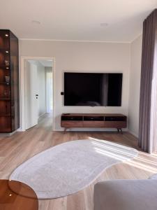 a living room with a large flat screen tv at Mõisavälja apartment in Rakvere