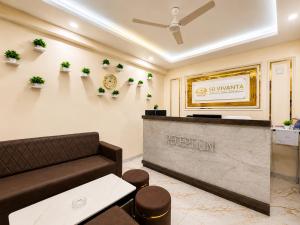 a waiting room with a couch and a reception desk at Hotel SR Vivanta,Brahmapur in Brahmapur