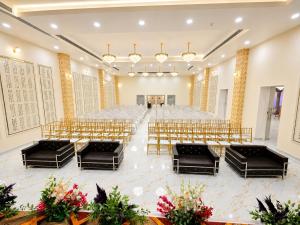 a banquet hall with rows of tables and chairs at Hotel SR Vivanta,Brahmapur in Brahmapur