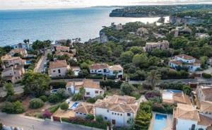 an aerial view of a village next to the ocean at Ocean Blues in Cala Santanyi