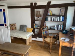 a living room with a couch and a book shelf at Ferme Alsacienne in Soppe-le-Haut